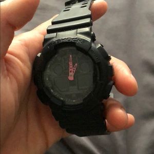 Men’s black G-shock watch with pink hands